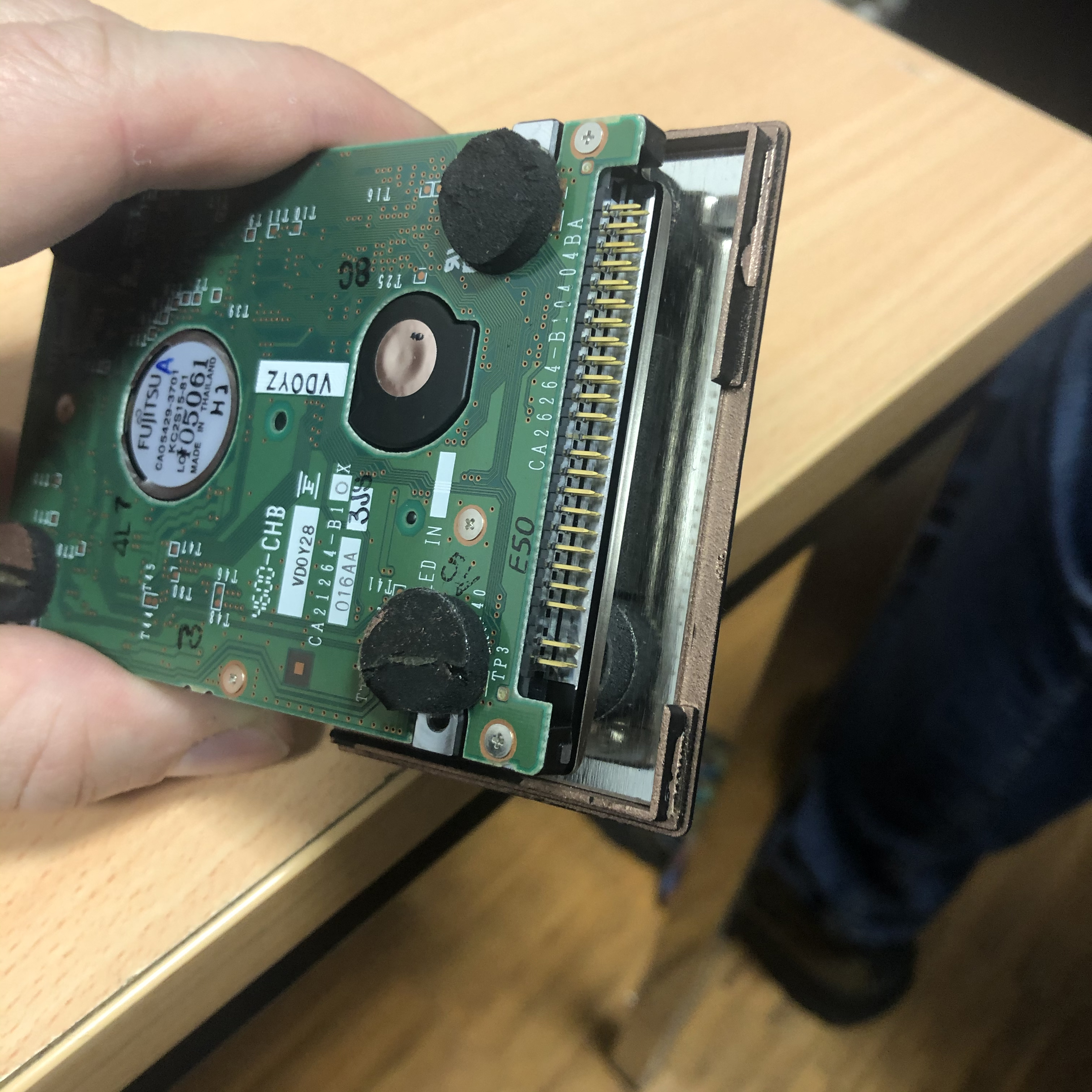 Unfortunately, removing the hard drive from its casing was a destructive process. The black dots are the dampers that needed to be cut.